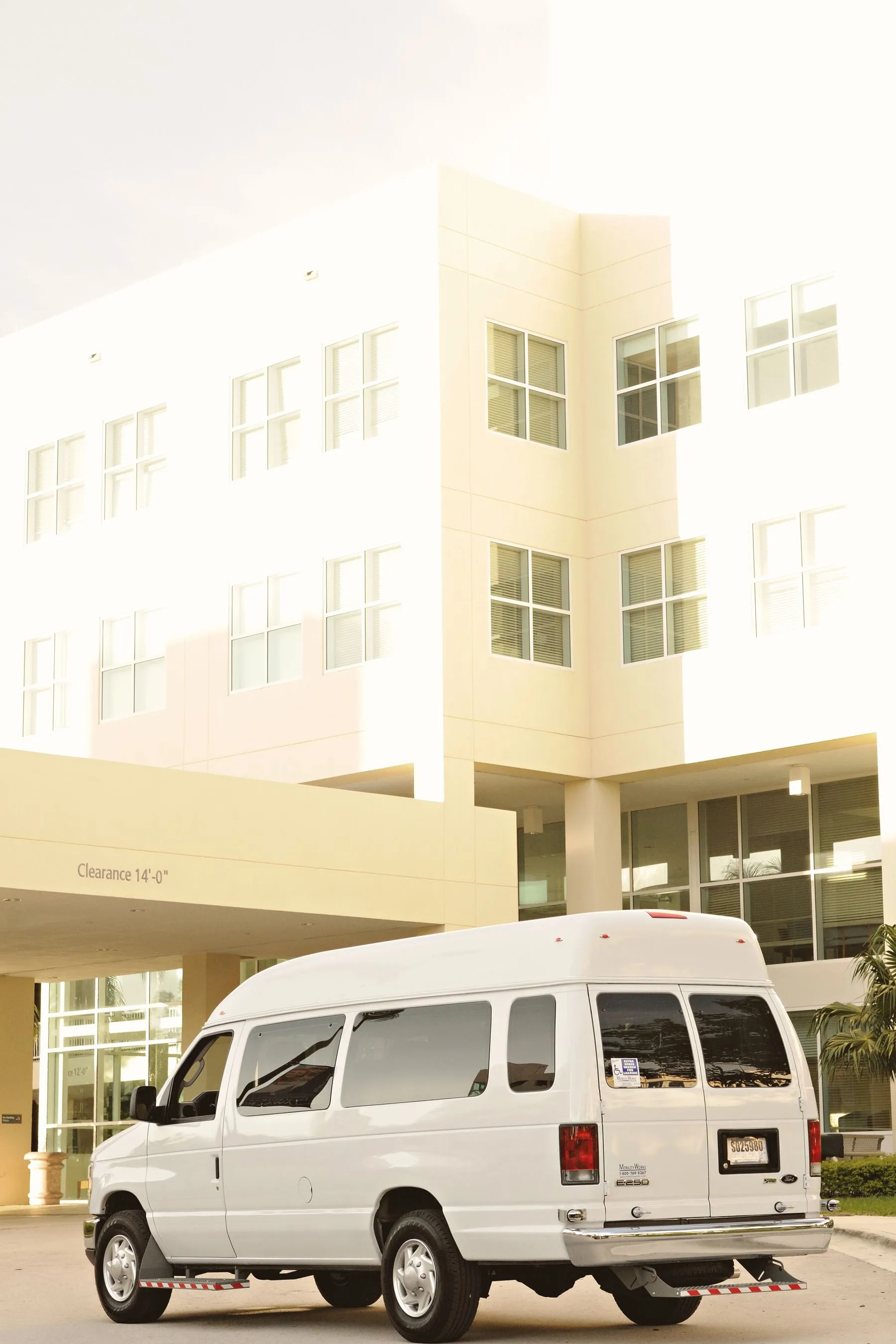 Plain white service van parked outside a building