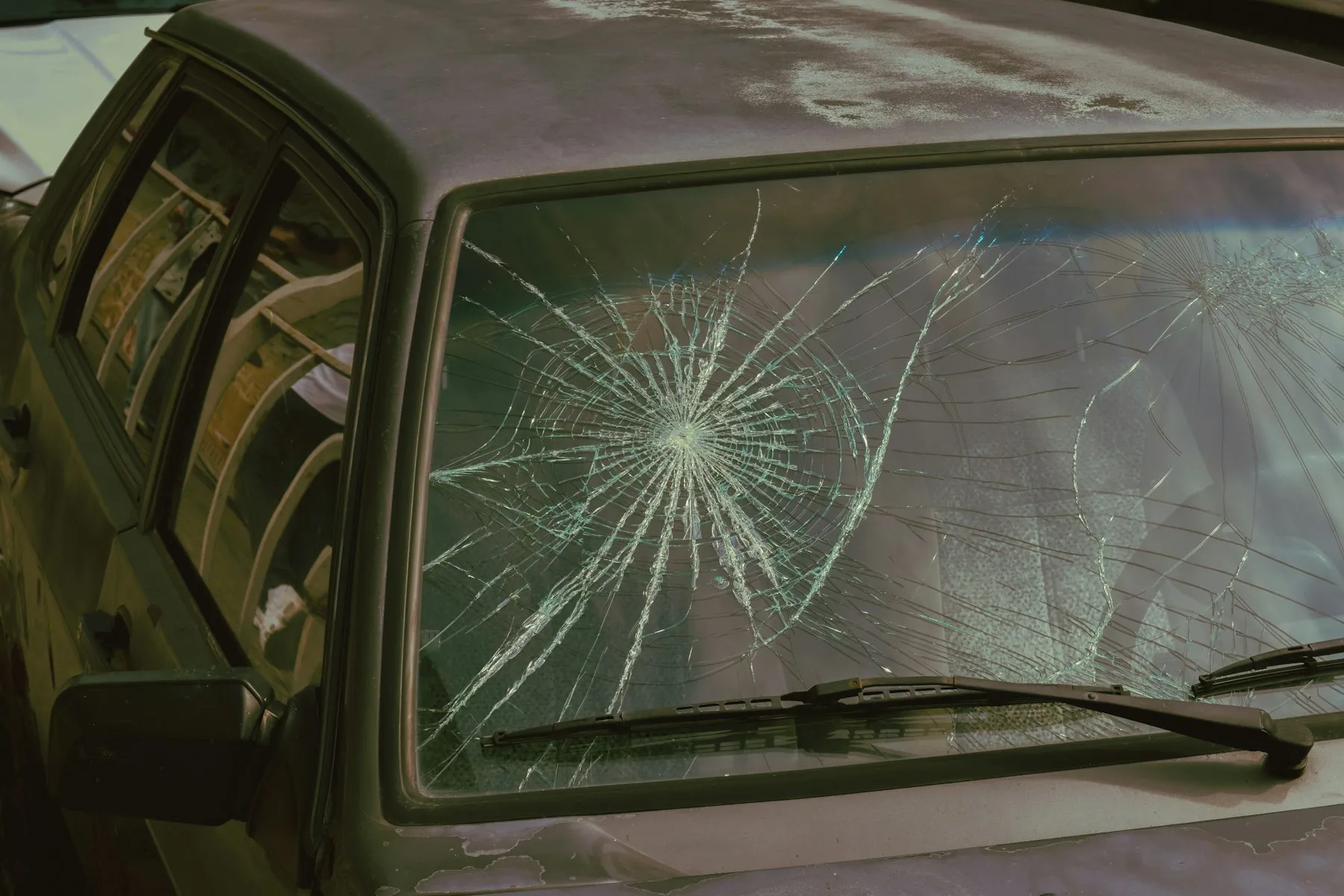 A star break spreading outward from an impact point on a windshield